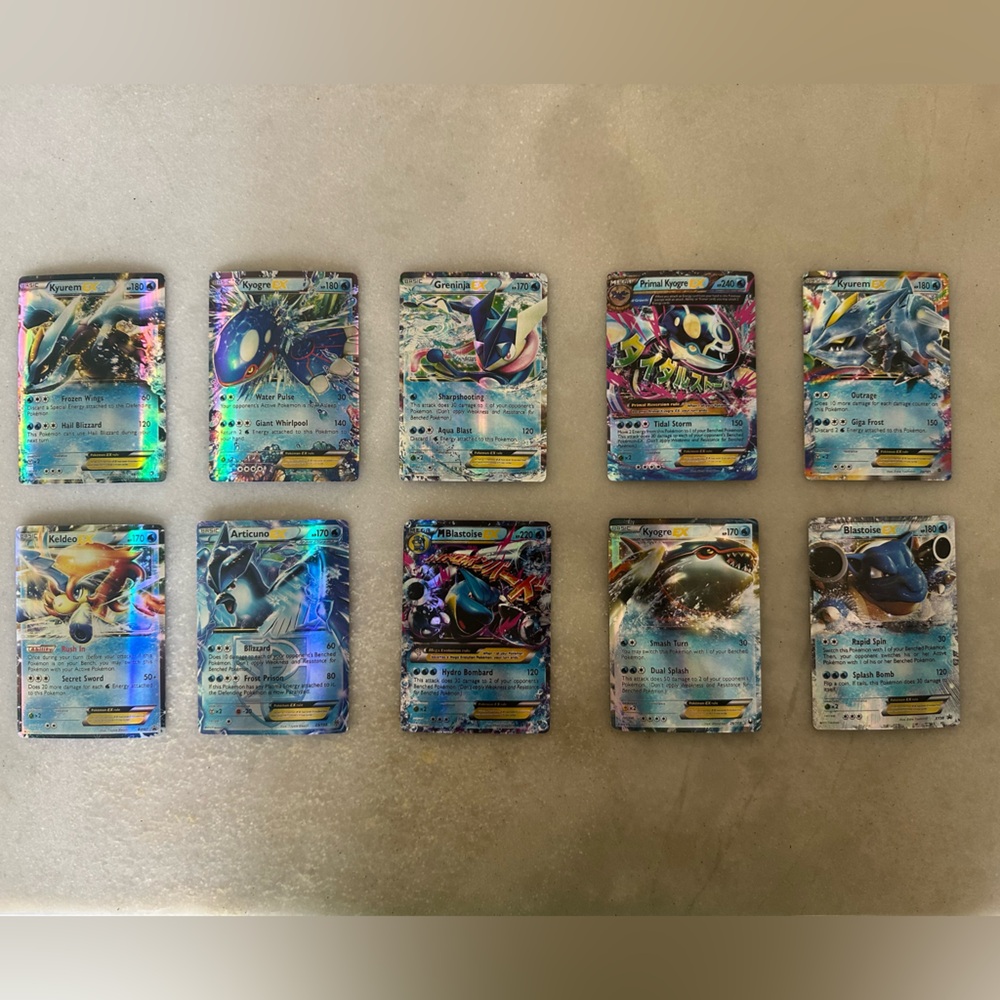 10 HOLOGRAPHIC WATER POKEMON TRADING CARDS, 2 megas, good condition